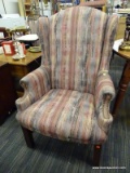 (R4) WINGBACK ARMCHAIR; PINK AND PASTEL UPHOLSTERED WINGBACK ARM CHAIR WITH BRONZE UPHOLSTERY NAILS