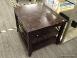 (R5) SIDE TABLE; SIDE TABLE WITH WOOD GRAIN, BLACK IN COLOR. HAS TWO LOWER SHELVES FOR STORAGE.