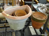 (R5) LOT OF PLANTERS AND CARDBOARD PAPER; LOT INCLUDES A ROLL OF CARDBOARD PAPER AND 7 TERRACOTTA