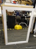 (R2) MIRROR IN A WHITE FRAME. SITS IN A WOOD GRAIN FRAME WITH A WHITE FINISH. MEASURES 24 IN X 35