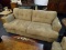 ASHLEY FURNITURE MICROFIBER SOFA; ZIA-MOCHA 3 PERSON SOFA WITH A LIGHT BROWN COLOR AND TUFTED