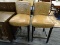 LEATHER BAR STOOLS; LIGHT BROWN LEATHER BAR STOOLS WITH A BLACK WOODEN FRAME WITH A BOX STRETCHER.