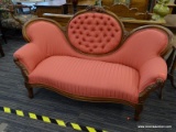 WALNUT VICTORIAN CAMEO BACK SETTEE WITH CARVED GRAPES AND BUTTON TUFTED CAMEO.