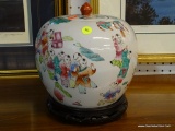 ORIENTAL HAND PAINTED GINGER JAR WITH LID SITTING ON A STAND.