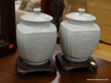 PAIR OF CELADON GREEN CERAMIC GLAZED ORIENTAL GINGER JARS ON ROSEWOOD STANDS. MEASURES 7 IN TALL.