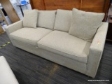 3-PERSON SOFA; CHAMPAGNE COLORED, YARN LIKE SOFA WITH 2 THROW PILLOW. IN GREAT CONDITION. MEASURES 7