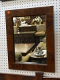 MIRROR SITTING IN A BURLED WALNUT FRAME. MEASURES 18 IN X 22.5 IN.