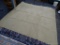 LIGHT BROWN AREA RUG; SOLID COLOR AREA RUG WITH A WOVEN LIKE PATTERN. MEASURES 124 IN X 124 IN.