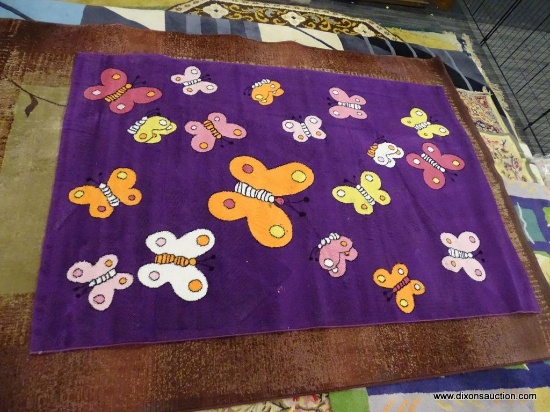KIDS COLLECTION AREA RUG; HAS A BUTTERFLY PATTER WITH A DARK PURPLE COLOR BASE. BUTTERFLIES AREA