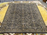 STANTON RUG COMPANY AREA RUG; WOOL AREA RUG WITH A MIDNIGHT COLOR AND A FLORAL PATTERN. HAS BEIGE