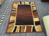 ARIANA MACHINE WOVEN AREA RUG; AZTEC LIKE AREA RUG WITH BLACK, BROWN, AND MAROON COLORS. MEASURES 4