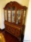 (DR) CUSTOM MADE 2 PC. CONTEMPORARY CHINA CABINET; CARVED SCROLL & LEAF DETAILED, ROPE DETAILING