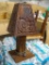 (GAR) CARVED TABLE LAMP; CARVED WOODEN TABLE LAMP WITH TRIBAL CARVINGS ON THE BASE AND SHADE.