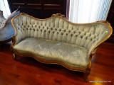 (LIBRARY) VICTORIAN CAMELBACK SOFA; PALE BLUE UPHOLSTERED WITH BUTTON TUFTED BACK. CARVED FLORAL