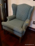 (UPSIT) VINTAGE UPHOLSTERED WING BACK CHAIR; GREENISH BLUE UPHOLSTERY WITH SHELL DETAILING. ROLLED