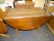 (R2) DROP LEAF TABLE; WOODEN TABLE WITH TWO 15.75 IN HALF-CIRCLE DROP LEAVES ON EITHER SIDE AND