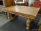 (R3) OAK DINING TABLE; TABLE COMES WITH A REED DETAILED SKIRT AND 4 VASE SHAPED, SHELL DETAILED LEGS