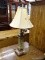 (R3) SQUARE PORCELAIN AND WOODEN TABLE LAMP; HAS A BEIGE GLAZED SCROLLING DETAILED PORCELAIN CENTER