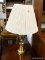 (R4) POLISHED BRASS TABLE LAMP COMES WITH A COOLIE FABRIC SHADE, SHADE HAS STAINS. MEASURES 25 IN