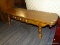 (R4) COFFEE TABLE; WOOD COFFEE TABLE WITH TURNED LEGS AND ONE FAUX DRAWER WITH THREE WHITE KNOBS. IN