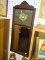 (WALL) ANTIQUE HANGING MIRROR; VERTICAL WOODEN MIRROR, HAS SCROLL AND FLORAL DETAILING ON TOP