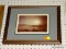 (WALL) FRAMED PHOTOGRAPH PRINT; DEPICTS A VIEW OF THE SUN ABOVE THE CLOUDS WITH TREES IN THE BOTTOM