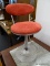 (R2) BARSTOOL; METAL BARSTOOL WITH PINK SUEDE UPHOLSTERY AND ADJUSTABLE HEIGHT. HAS FOOTREST AND