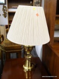 (R4) POLISHED BRASS TABLE LAMP COMES WITH A COOLIE FABRIC SHADE, SHADE HAS STAINS. MEASURES 25 IN