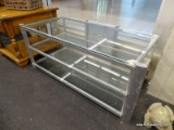 (WINDOW) TV STAND; THREE TIERED GLASS TOP MODERN TV STAND. HAS A SILVER FRAME. MEASURES 50 IN X 23.5