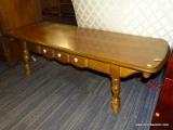 (R4) COFFEE TABLE; WOOD COFFEE TABLE WITH TURNED LEGS AND ONE FAUX DRAWER WITH THREE WHITE KNOBS. IN