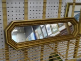 (WALL) SMALL WALL HANGING MIRROR; OCTAGONAL MIRROR WITH A GOLD TONE FRAME. MEASURES 17.75 IN X 5.25