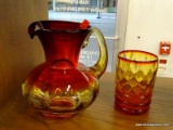 (R1) CUP AND PITCHER; HAND BLOWN CARNIVAL GLASS CUP AND PITCHER WITH RED AND AMBER TINT.
