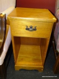 (R1) SIDE TABLE; WOODEN SIDE TABLE, HAS SINGLE PULL OUT DRAWER WITH BRONZE PULL ABOVE LOWER OPEN