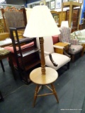 (R1) FLOOR LAMP; WOODEN TURNED FLOOR LAMP WITH A ROUND CENTER SHELF, THREE TURNED LEGS, AND A