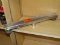 (R4) DESIGNLINE, 2 FT, LINEAR SHOWER DRAIN WITH A SQUARE GRATE PATTERN AND A STAINLESS STEEL FINISH.