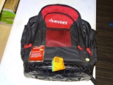 (R6) HUSKY 18 IN JOBSITE TOOL BACKPACK. RED AND BLACK IN COLOR WITH AMPLE STORAGE.