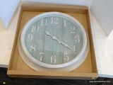 (R2) ROUND, WALL HANGING, ANALOG CLOCK WITH A WORN AQUA BACKGROUND AND A WORN CREAM FRAME. HAS A 22