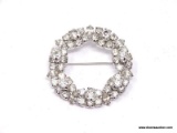 LADIES RHINESTONE BROOCH; ROUND LADIES SILVER STONE BROOCH WITH RHINESTONES. MEASURES 1 1/2 IN