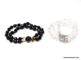 PAIR OF MULTI-STRAND COSTUME BRACELETS; INCLUDES A 3 STRAND CLEAR BEAD BRACELET WITH RHINESTONE