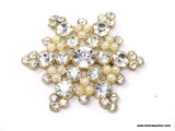 SMITHSONIAN MUSEUM LADIES BROOCH; LARGE SNOWFLAKE SHAPED GOLD TONE BROOCH WITH RHINESTONES AND FAUX
