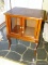 (DEN) SMALL CONSOLE CABINET; MAHOGANY 2 GLASS DOOR CONSOLE CABINET WITH A SCALLOPED SKIRT AND