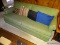 (DEN) ROLL ARM SOFA; GREEN UPHOLSTERED, 2-CUSHION SOFA. COMES WITH 4 MISMATCHING THROW PILLOWS.