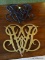 (DEN) VIRGINIA METALCRAFTERS TRIVETS; 2 PIECE LOT TO INCLUDE A BRASS TRIVET AND A BLACK IRON TRIVET.