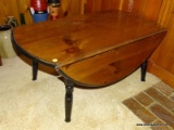 (DEN) DROP LEAF COFFEE TABLE; PINE, OVAL COFFEE TABLE WITH A BLACK PAINTED RIM, SKIRT, AND LEGS, (2)