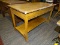 (R2) WORK TABLE; OAK WORK TABLE WITH A LOWER SHELF AND WOODEN CASTERS. MEASURES 48.5