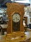 (R2) ANTIQUE PARLOR CLOCK; ANTIQUE OAK MANTLE CLOCK WITH SCROLL CARVED DETAILING AND GOLD PAINTED