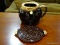 (R3) JAR AND TRIVET; 2 PC LOT OF DARK BROWN STONEWARE TO INCLUDE A JAR WITH A HANDLE AND A
