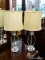(R1) PAIR OF GLASS TABLE LAMPS; SET OF 2 CRYSTAL GLASS LAMPS WITH A BALL FINIAL AND AN OVAL CREAM