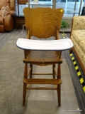(R2) TIGER'S OAK HIGH CHAIR; SCALLOPED BACK HIGH CHAIR WITH A DROP DOWN ENAMELED PORCELAIN EATING