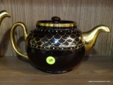 (R3) STAFFORDSHIRE TEAPOT; ONE DARK BROWN TEAPOT WITH A GOLD HANDLE AND SCALING WITH COLORED DOTS